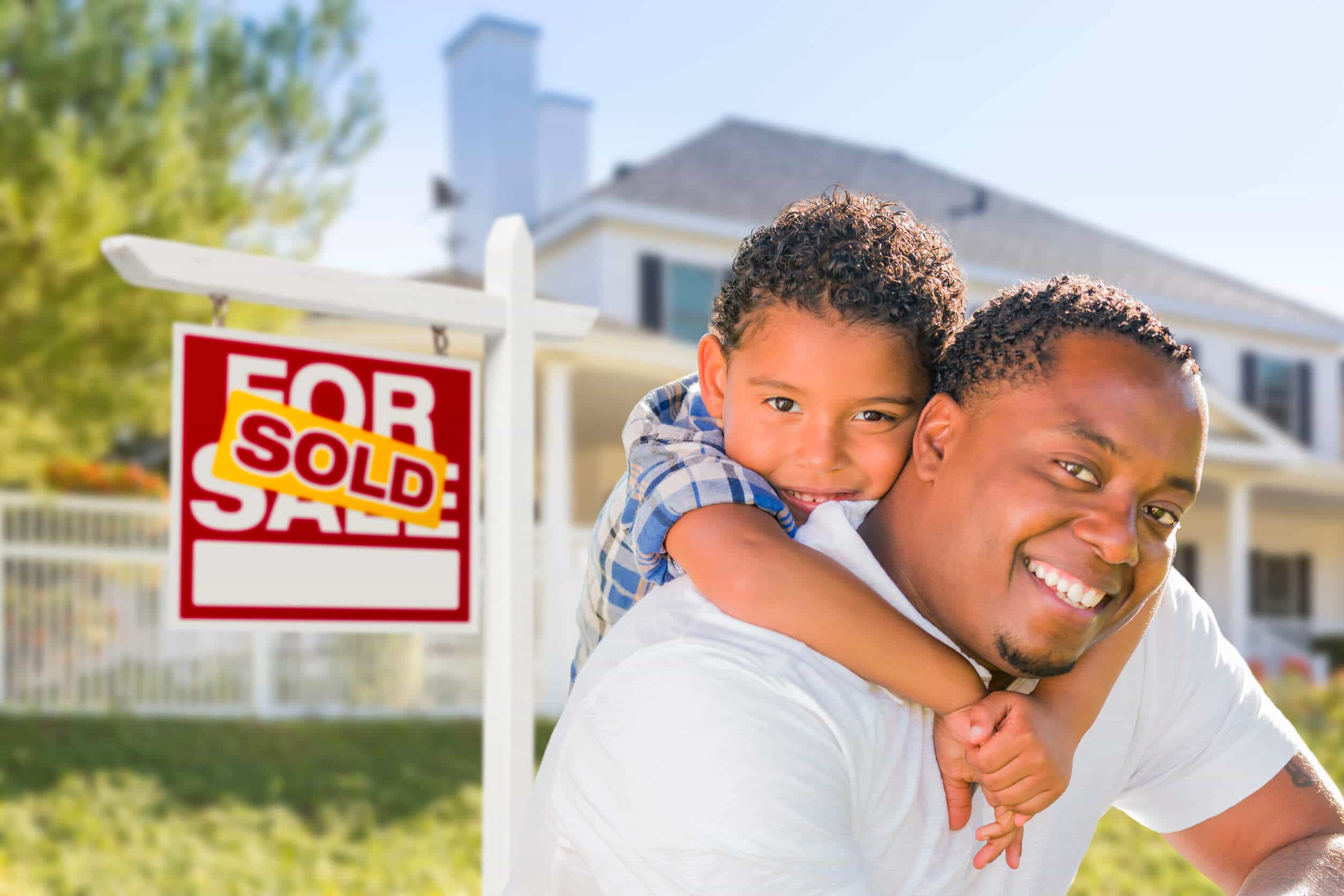 man and son with real estate sign